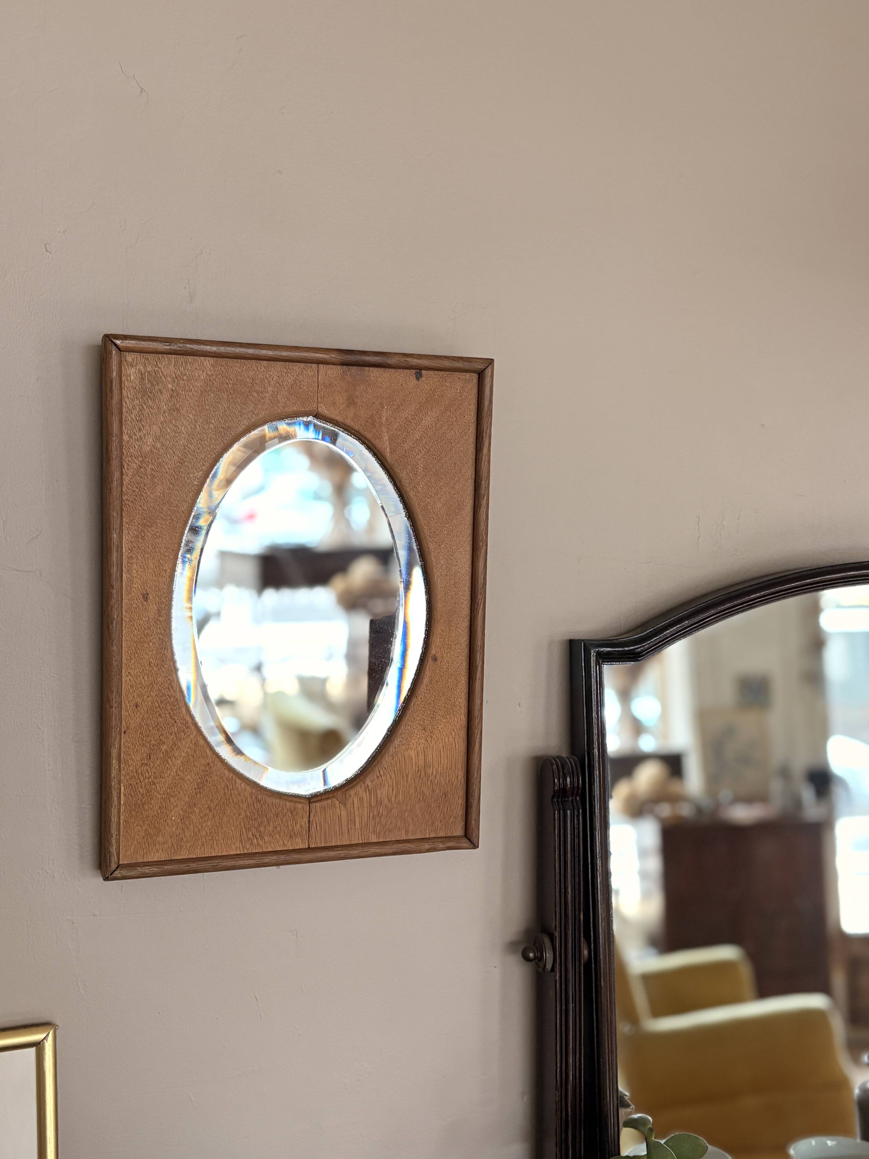 Bevelled oval mirror on oak frame