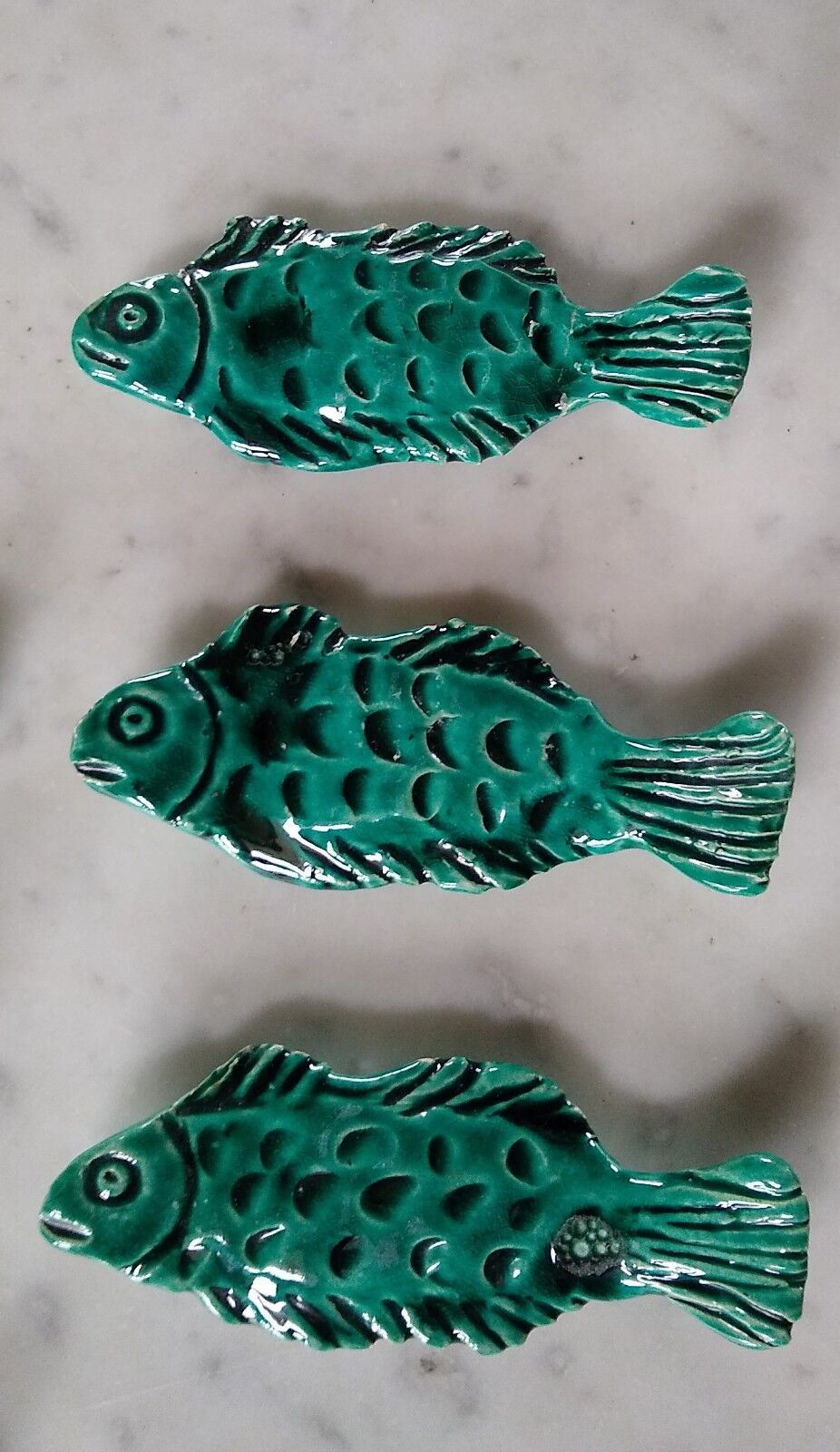 9 knife holders in green earthenware in the shape of a fish