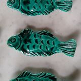 9 knife holders in green earthenware in the shape of a fish