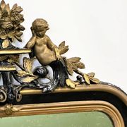 Antique 1800s black and gold mirror with cupid, France 1800s.