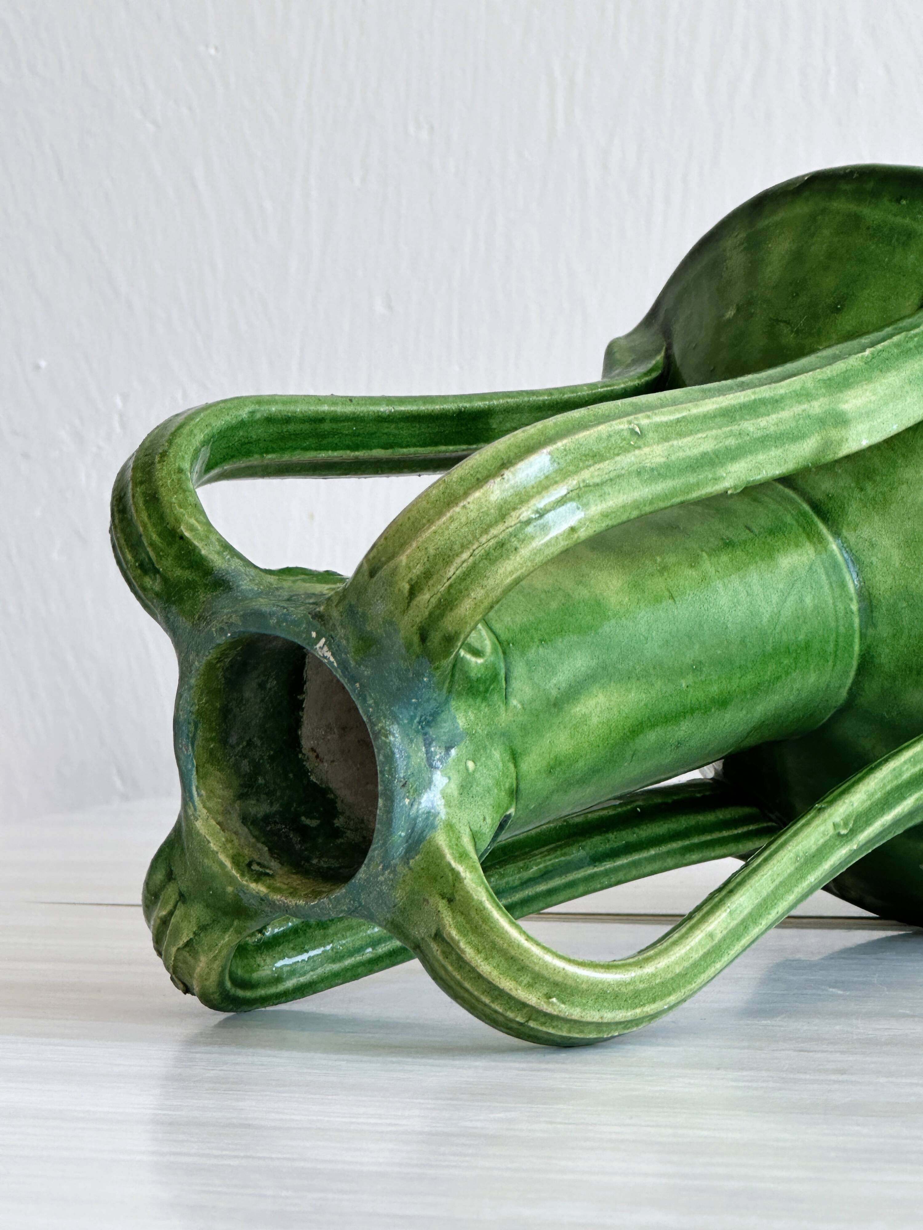 Pottery green ceramic vase with four handles.