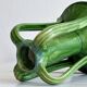 Pottery green ceramic vase with four handles.