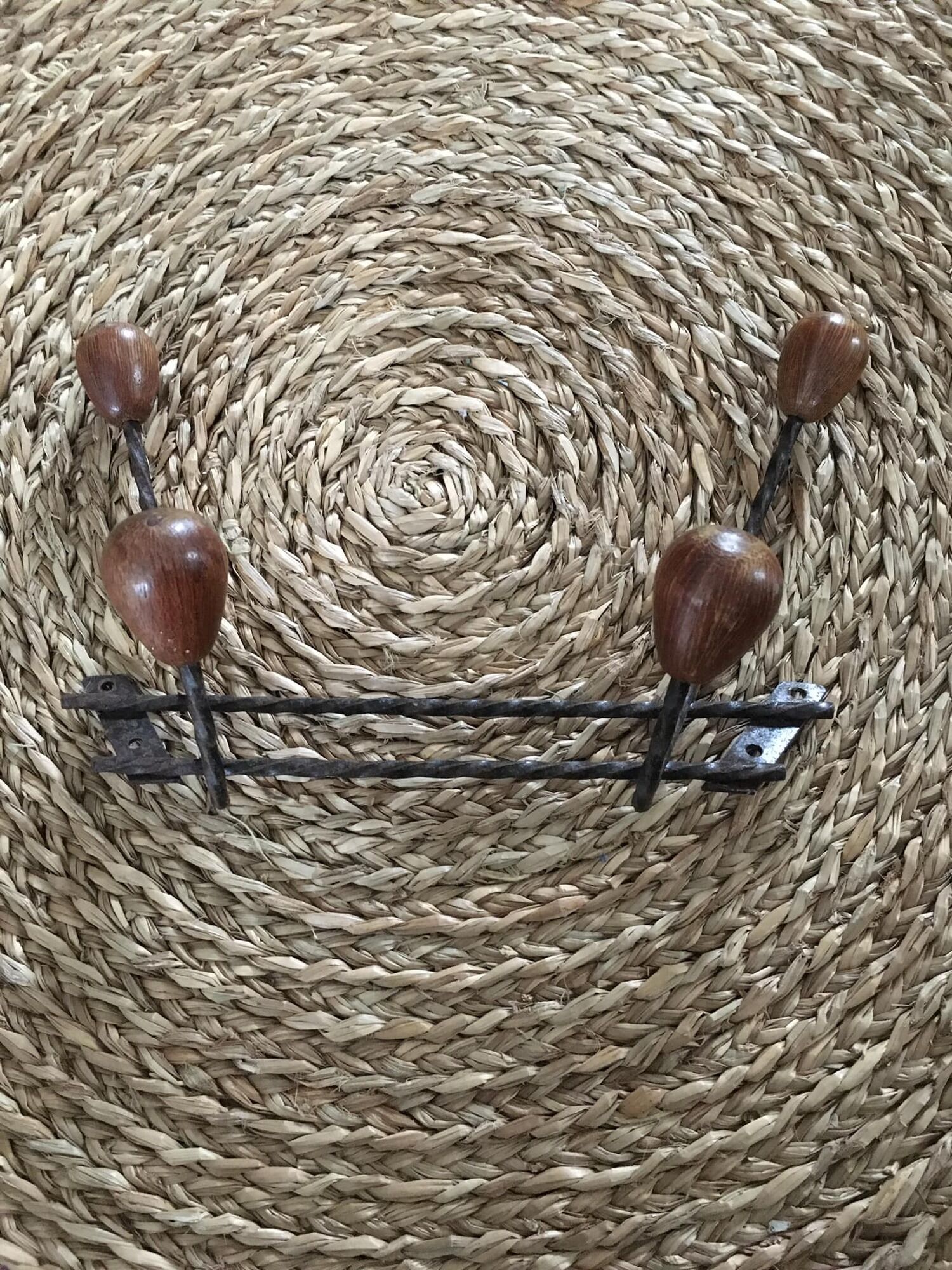 Old wrought iron coat rack. 4 hooks in chestnut wood