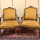 Pair of faux Louis XV armchairs in fully carved walnut