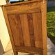 Furniture with a cherry wood door.