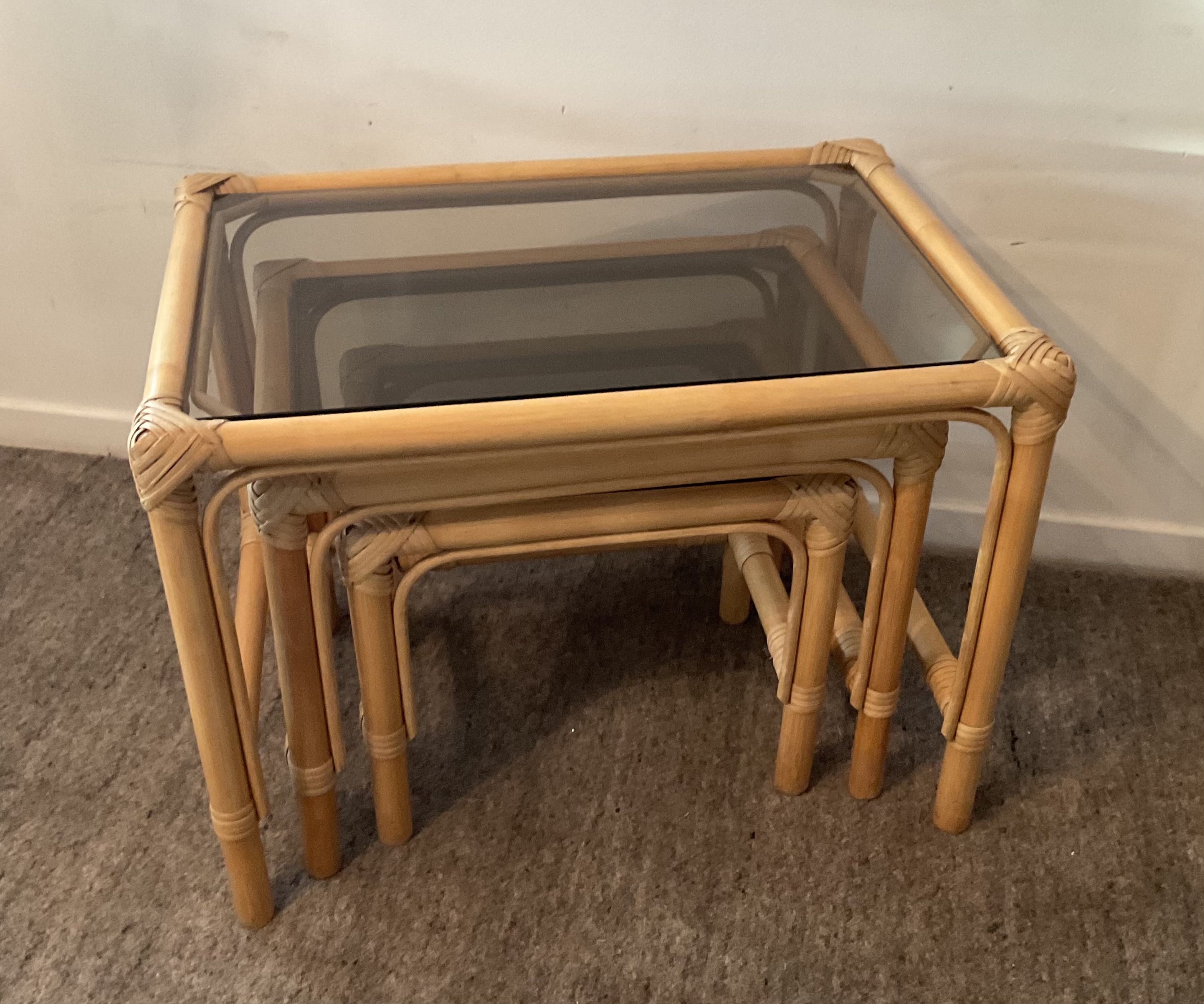 Trio of vintage pull-out tables in rattan and smoked glass 70s