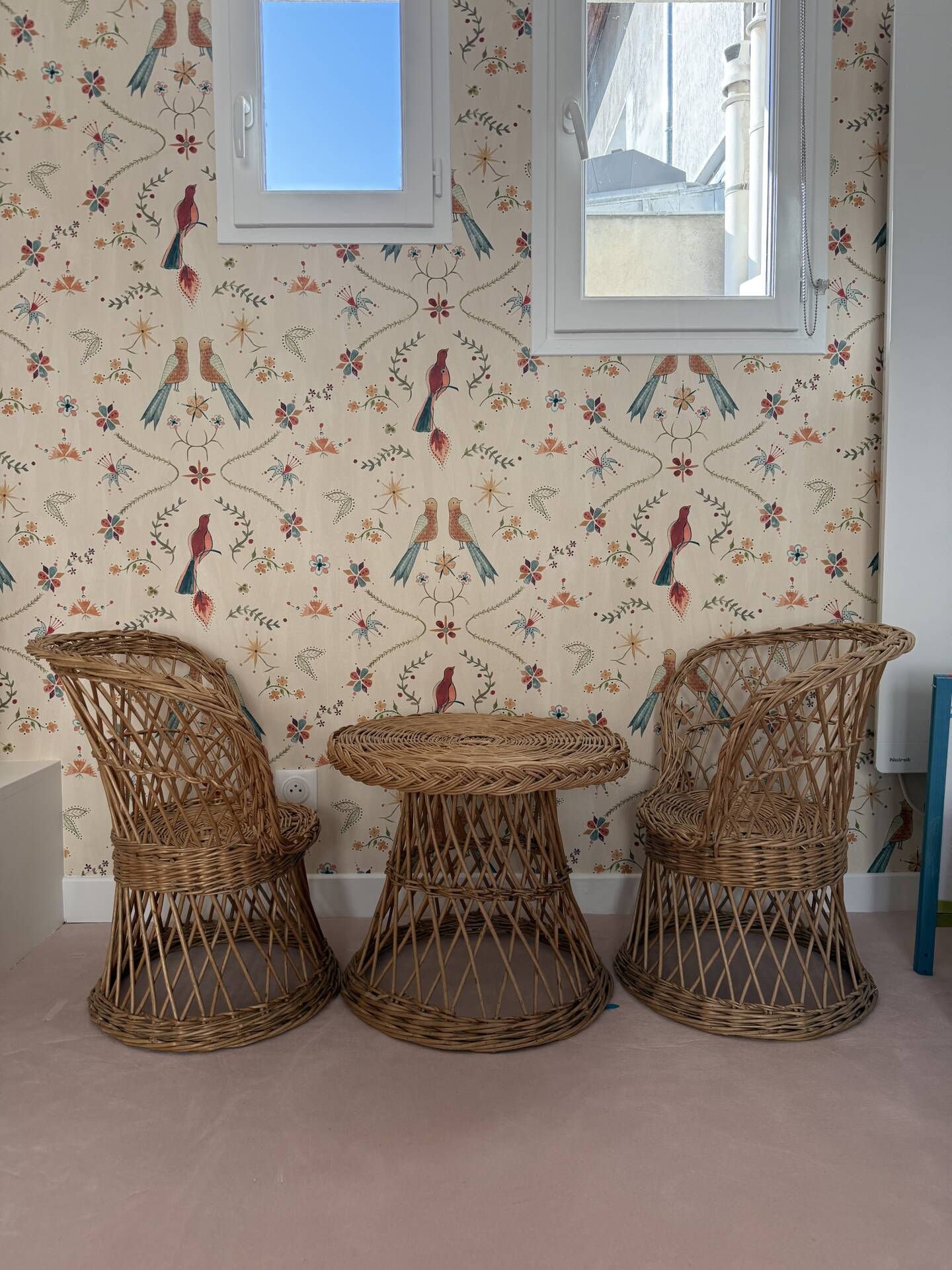 Table and two wicker chairs for children.