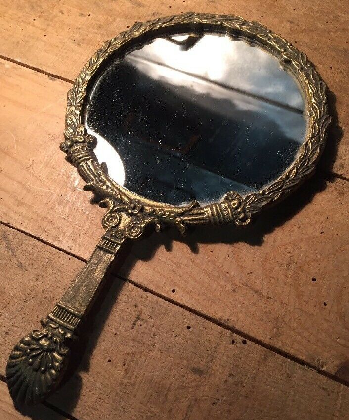 Antique mirror facing round hand in bronze 23cm