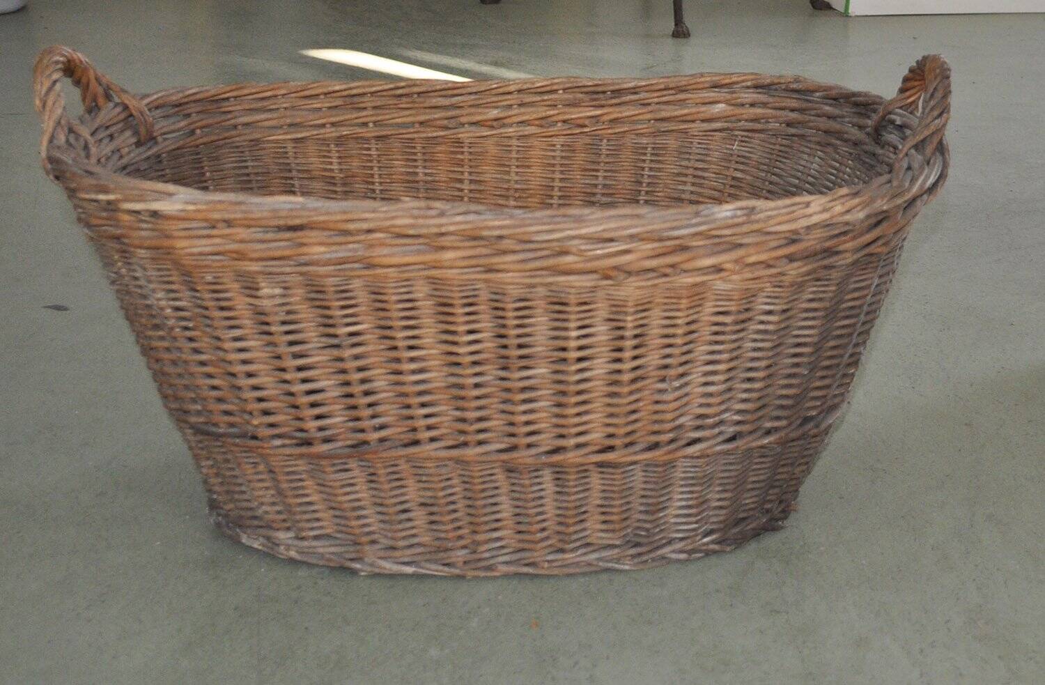 Rustic brown wicker basket from the 1940s — large oval laundry basket