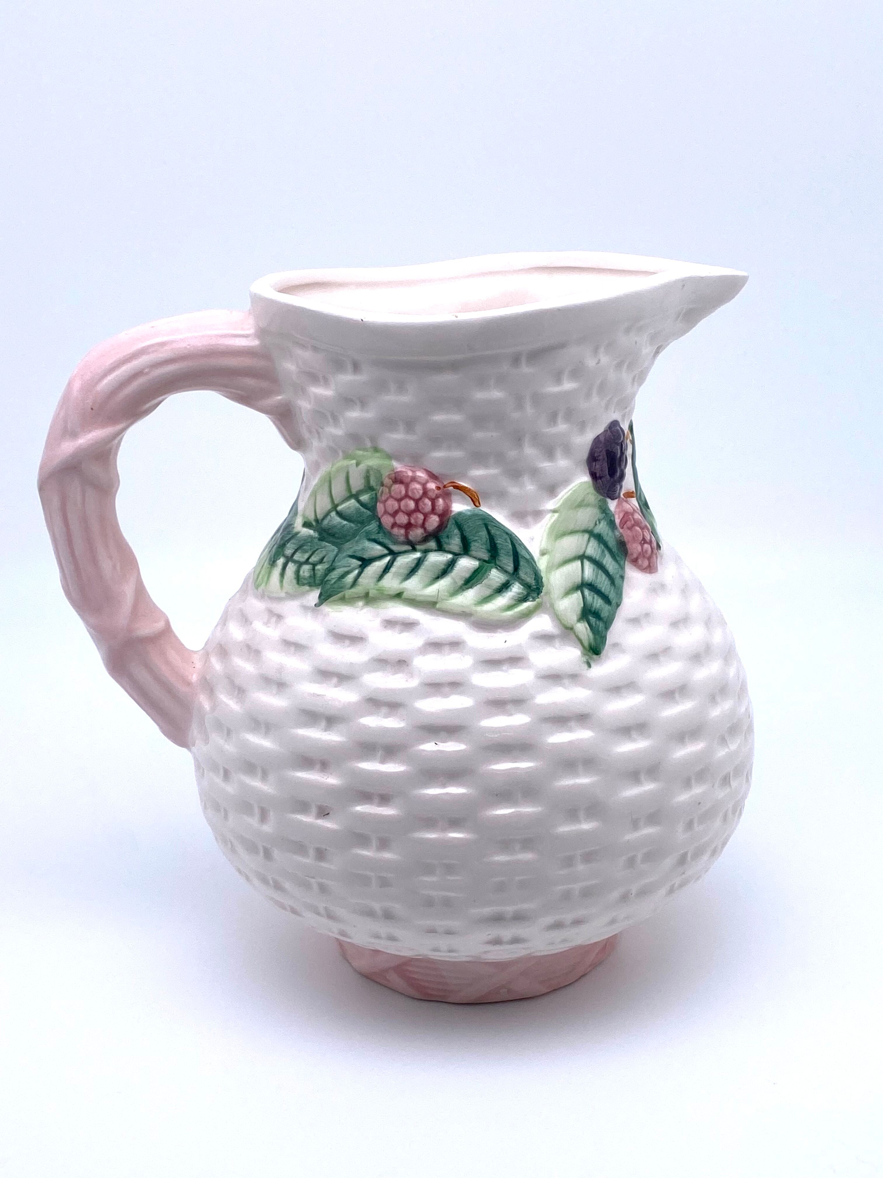 Pale pink slip decanter and colorful fruist