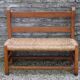 Wooden-backed bench with straw seat, 1970s.