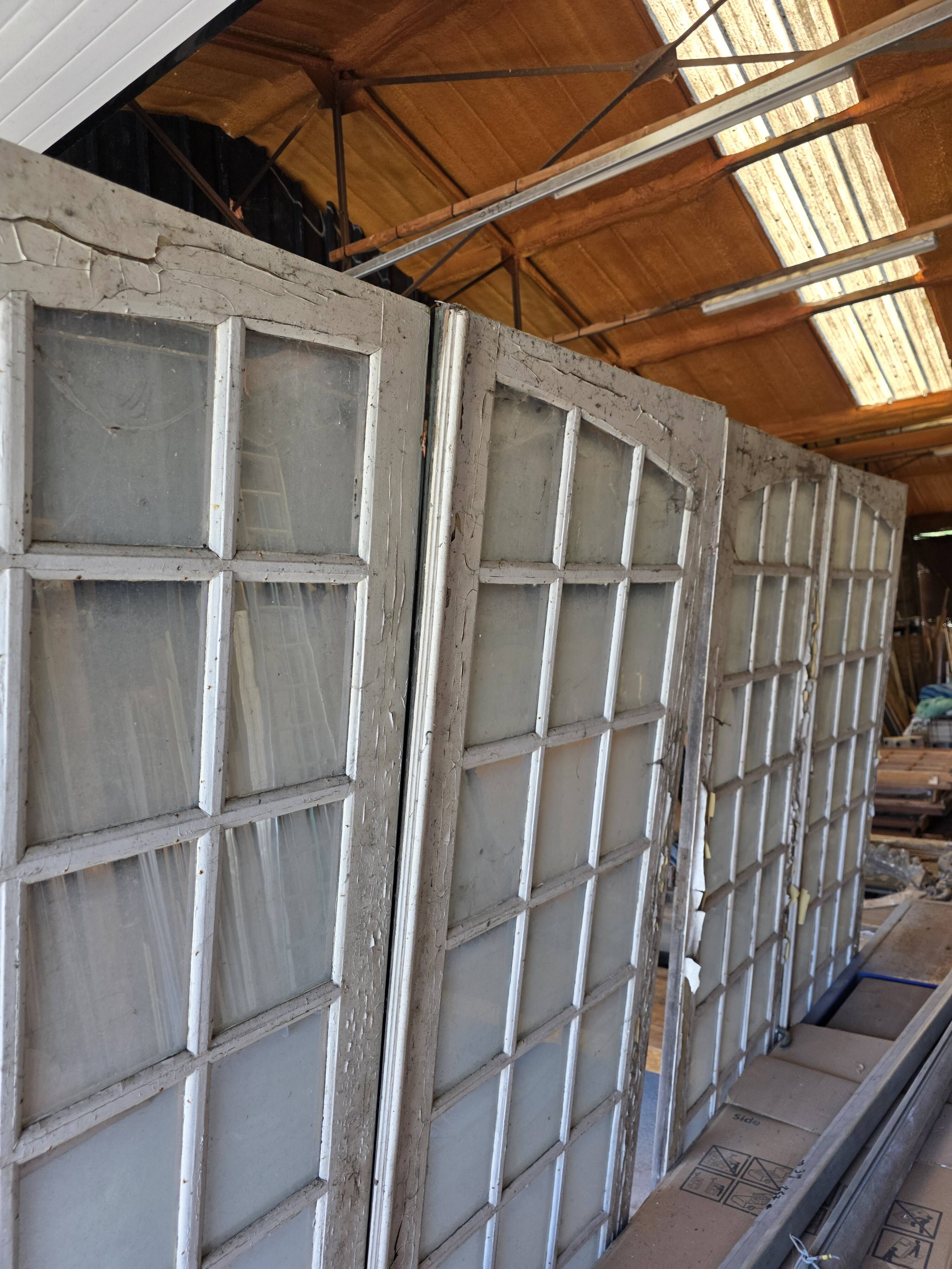 Two pairs of solid oak doors with small panes.