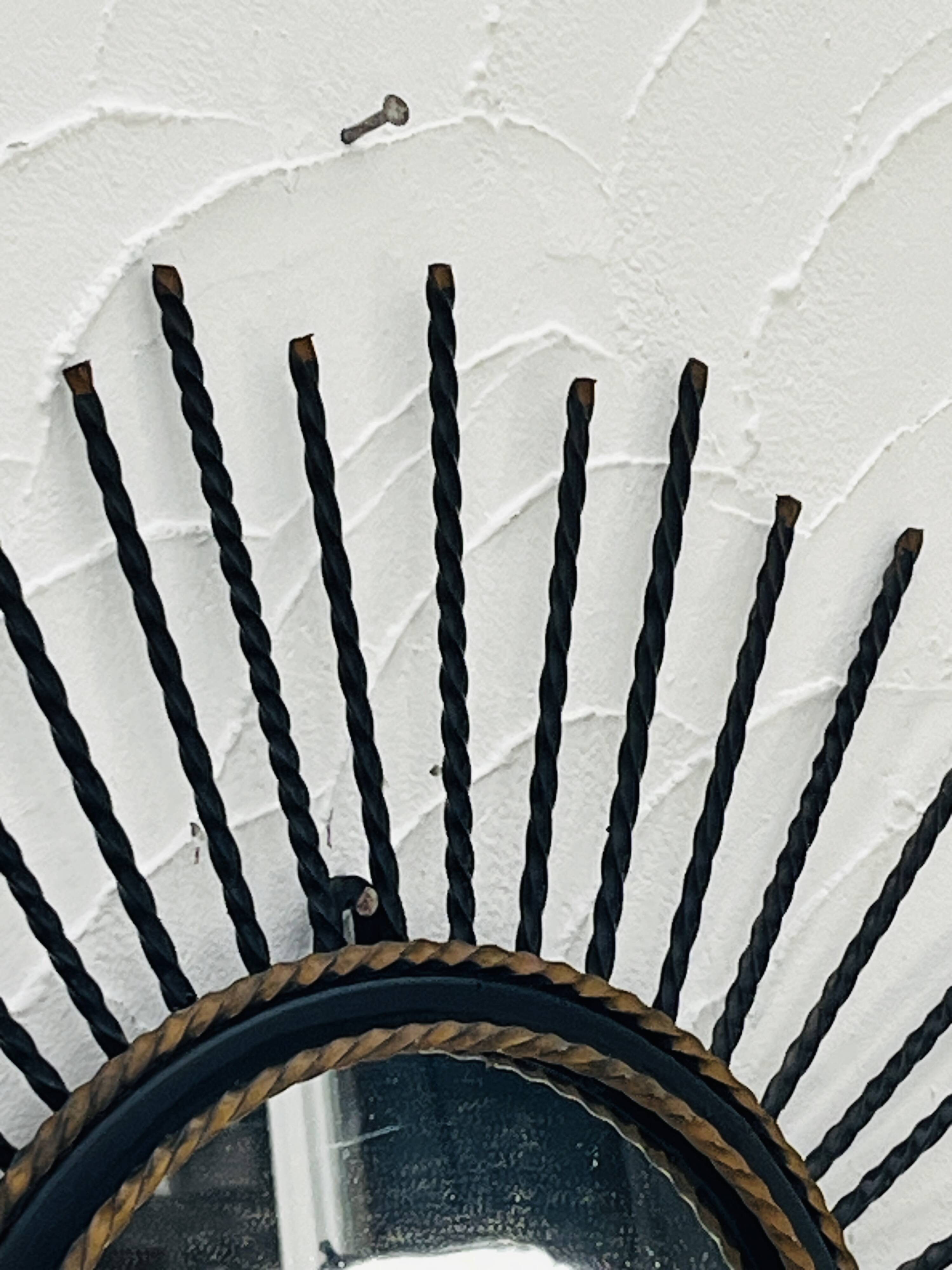 Vintage black and gold metal sun mirror from the 1960s.