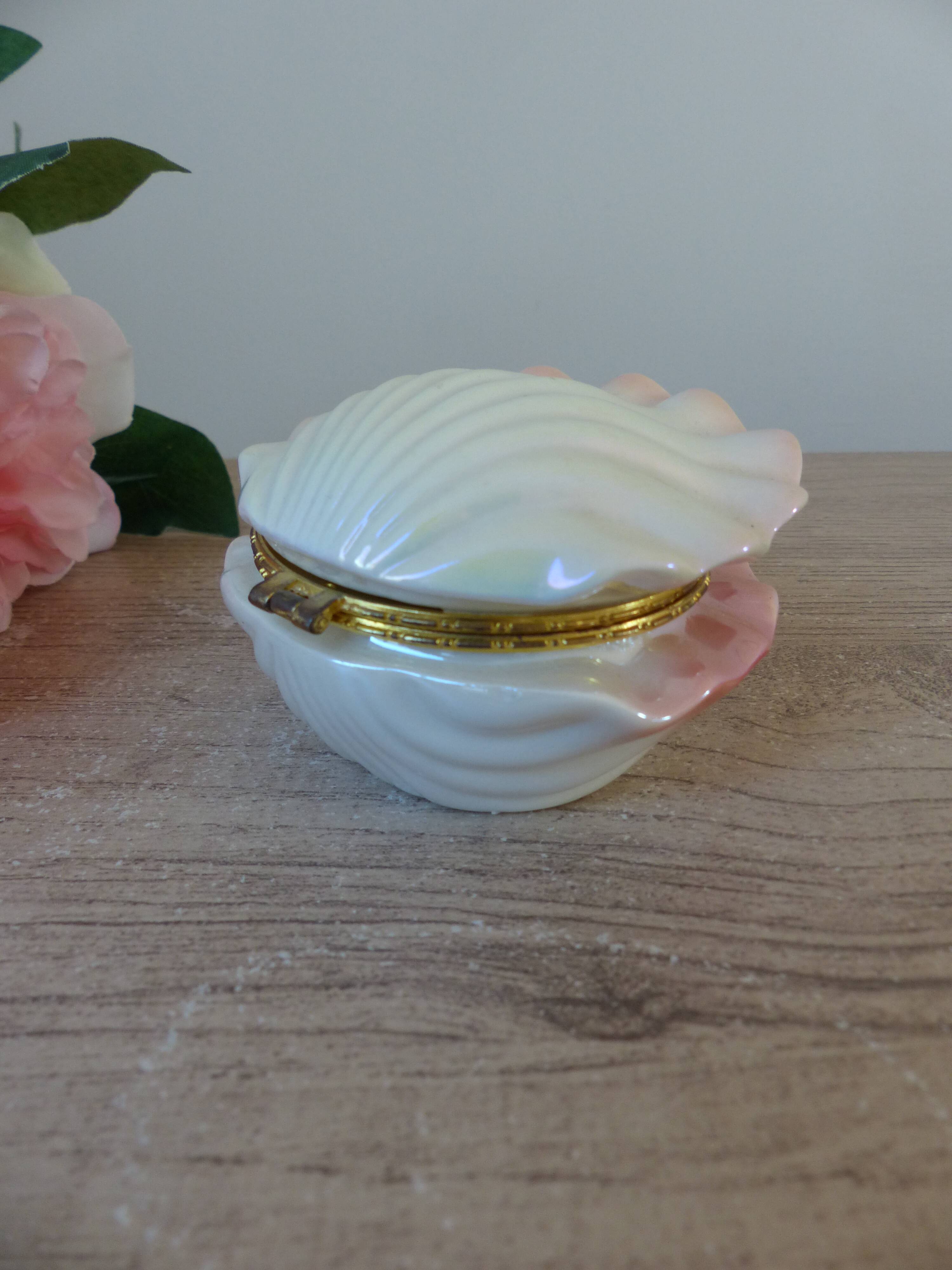 Vintage shell-shaped catchall in iridescent cream and pink ceramic.
