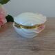 Vintage shell-shaped catchall in iridescent cream and pink ceramic.