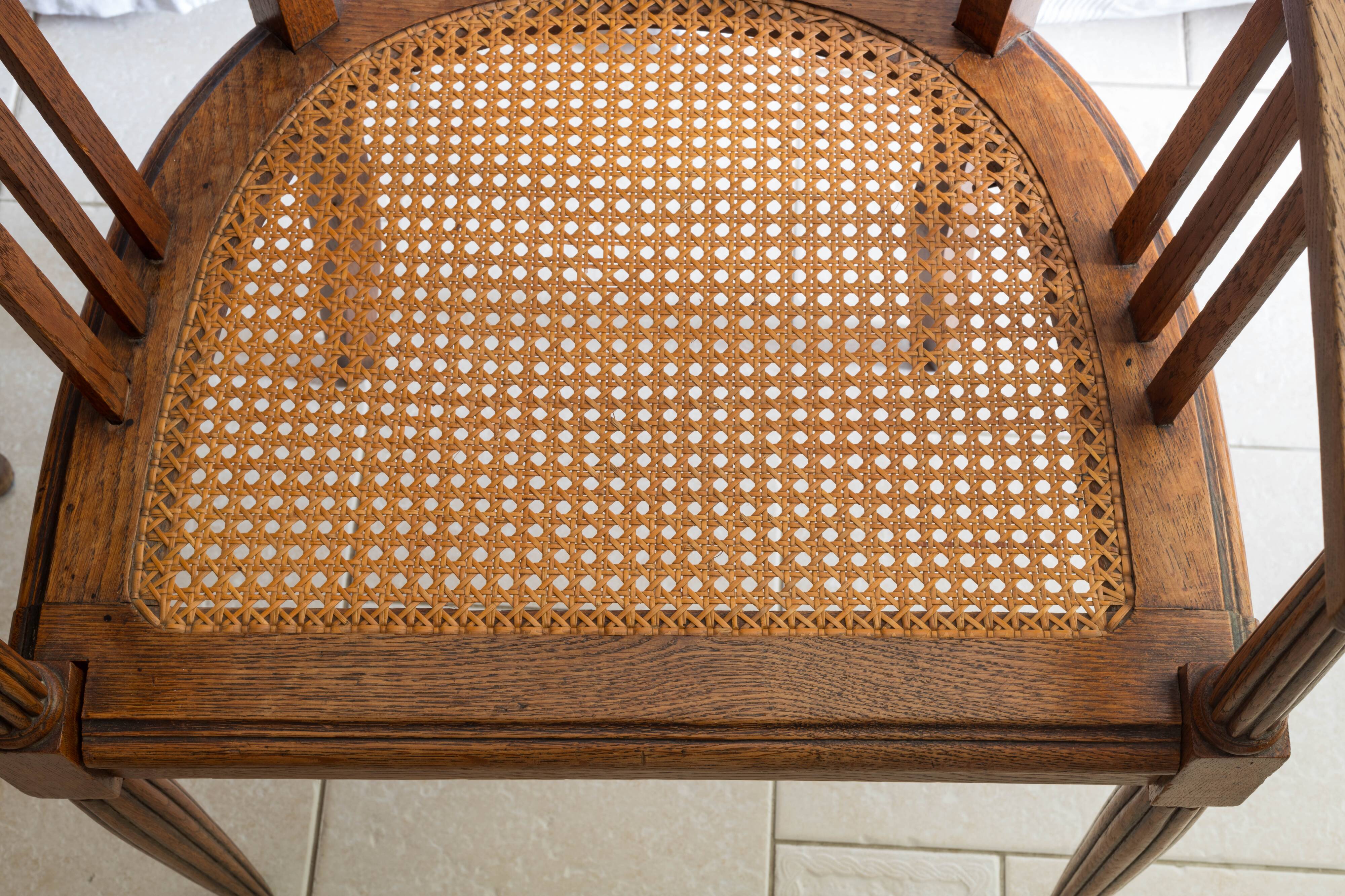 Antique armchair and stool with caned seat and fluted legs