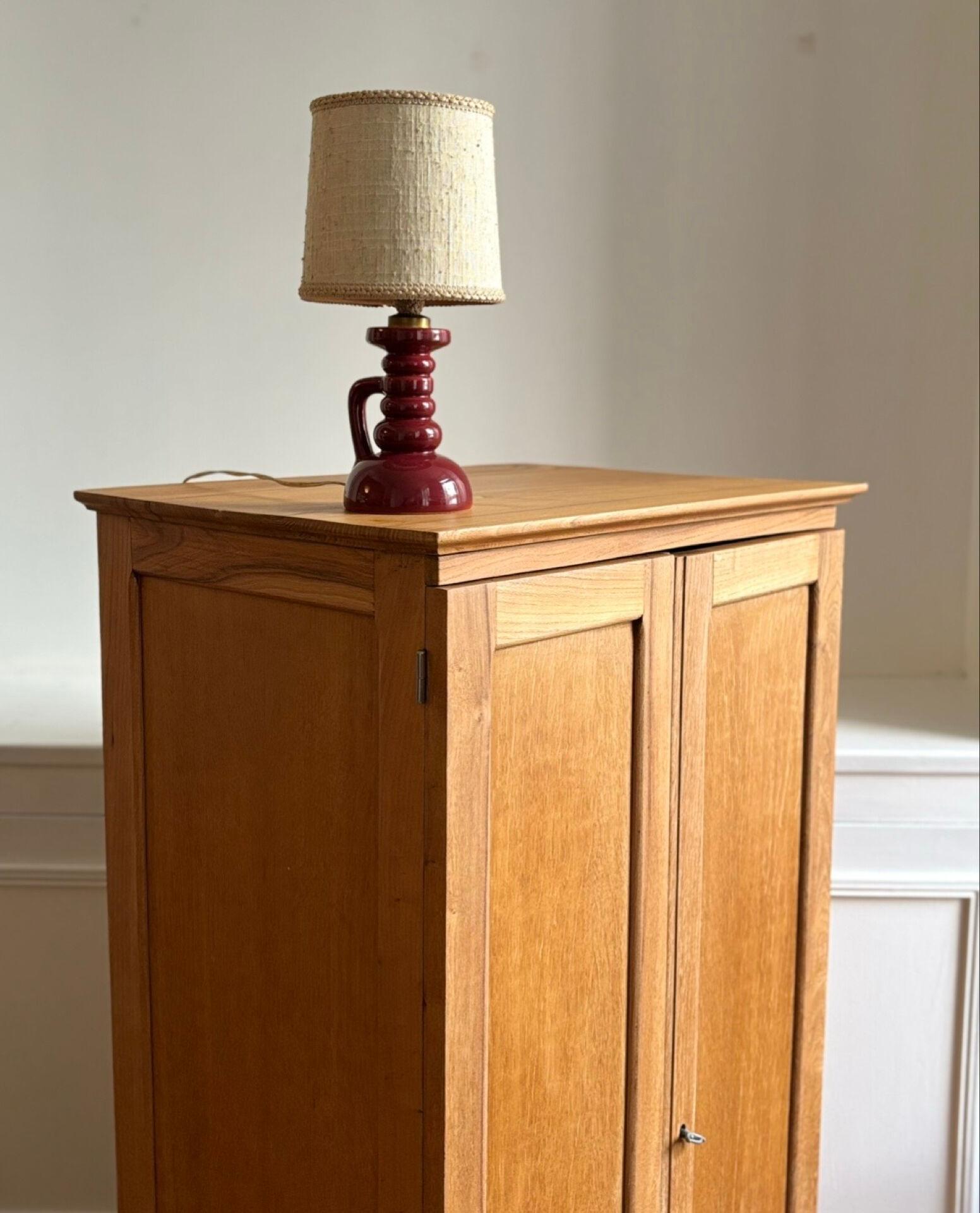 Small oak cabinet with tapered legs.
