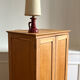 Small oak cabinet with tapered legs.