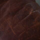 Dark red upholstered camel saddle stool, 20th century, North Africa.