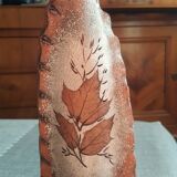Small clay vase decorated with leaves