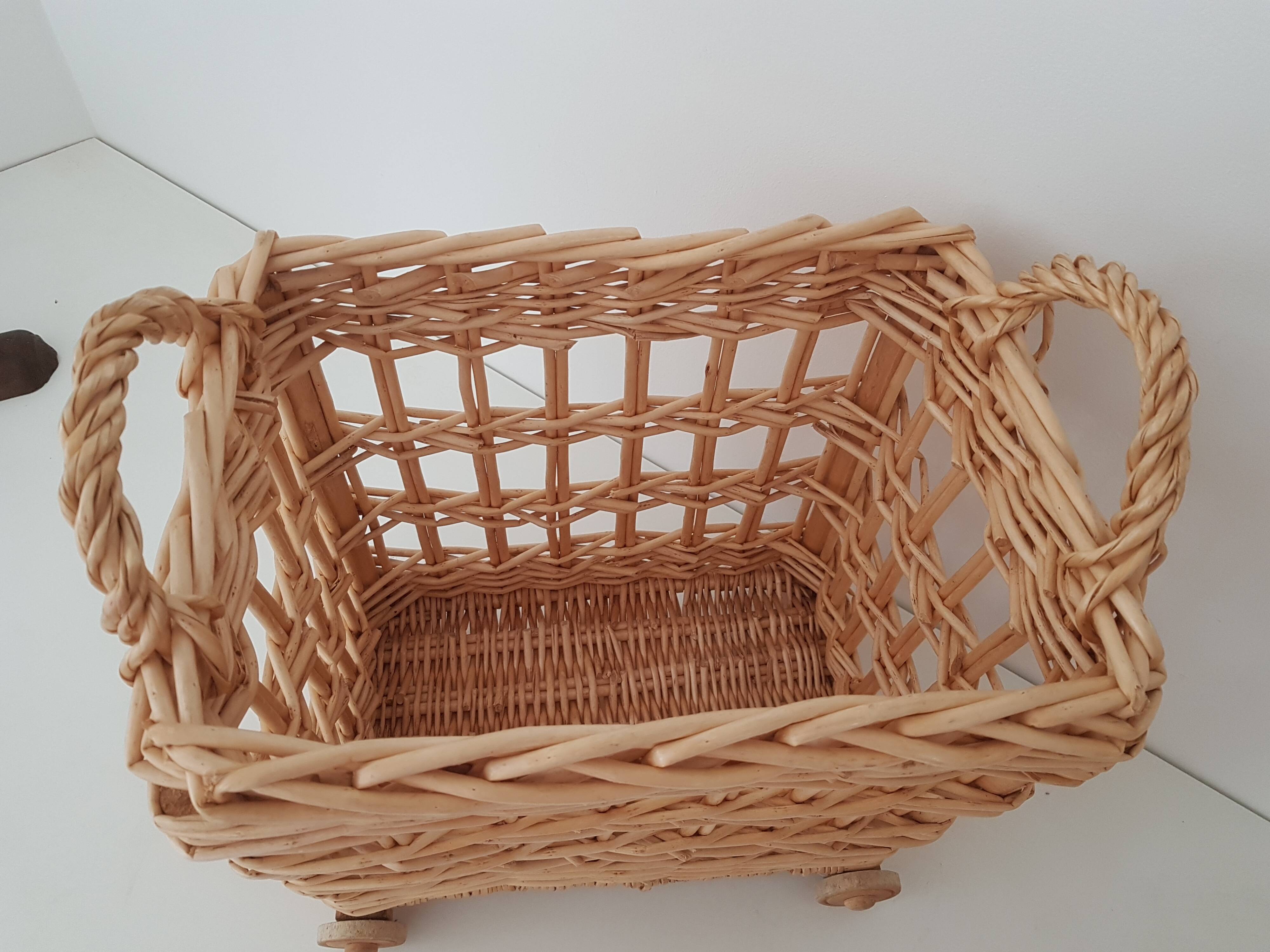 Vintage wicker basket on wheels - children's toy trolley