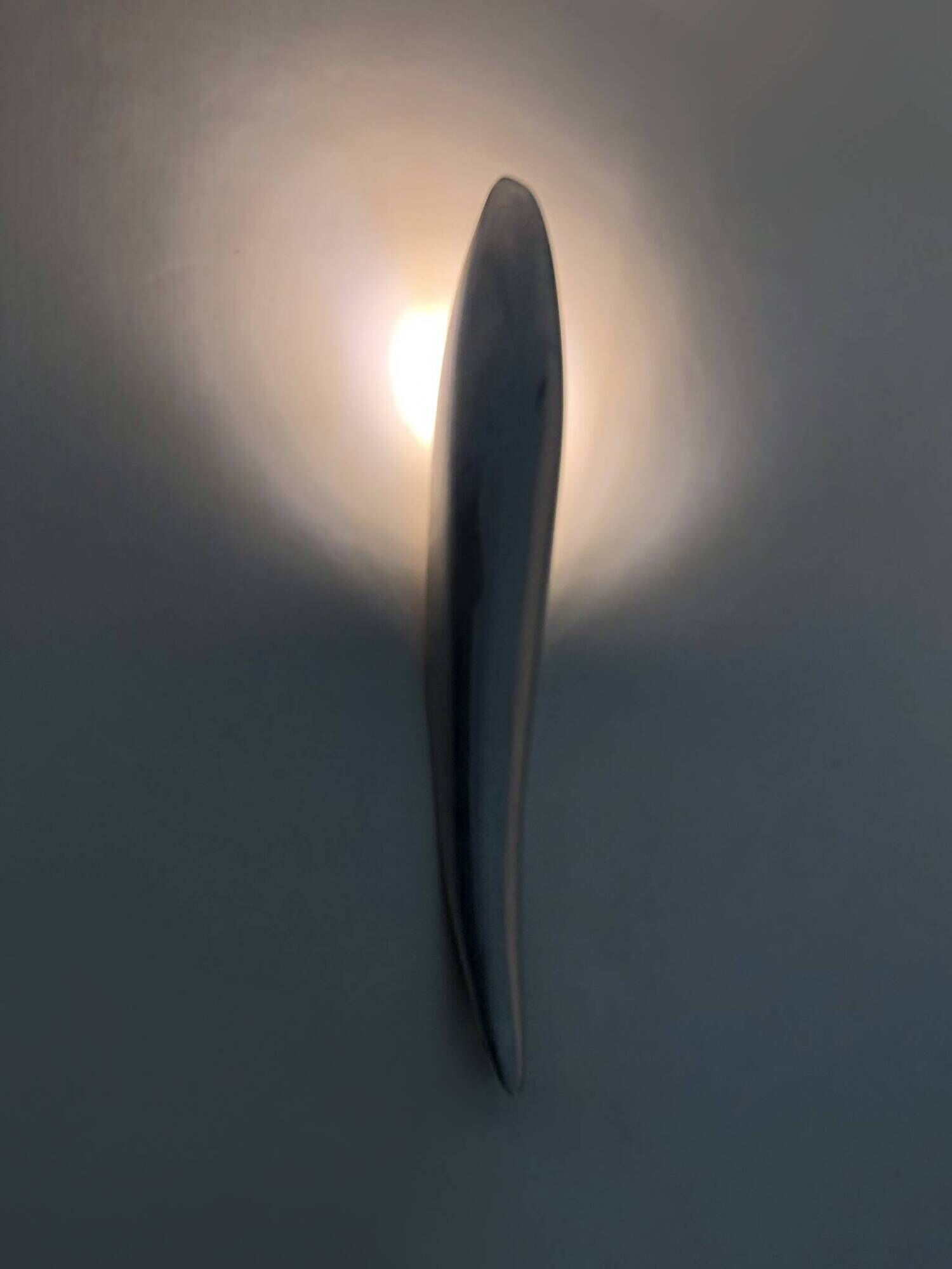 Pair of designer wall sconces in aluminium in the style of Lucien Gau.