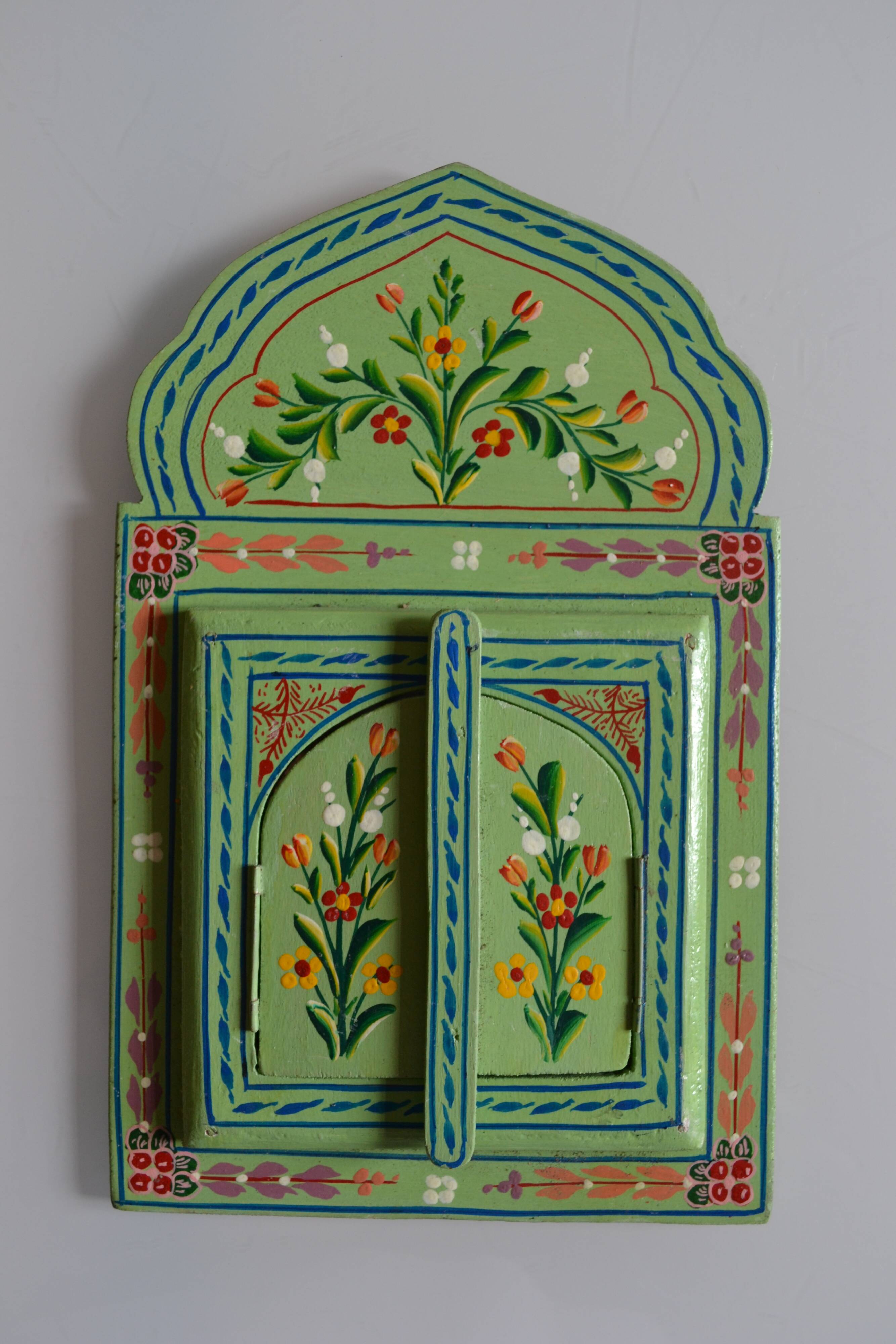 Mirror under shutters with painted flower decoration
