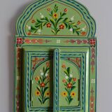 Mirror under shutters with painted flower decoration