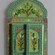 Mirror under shutters with painted flower decoration