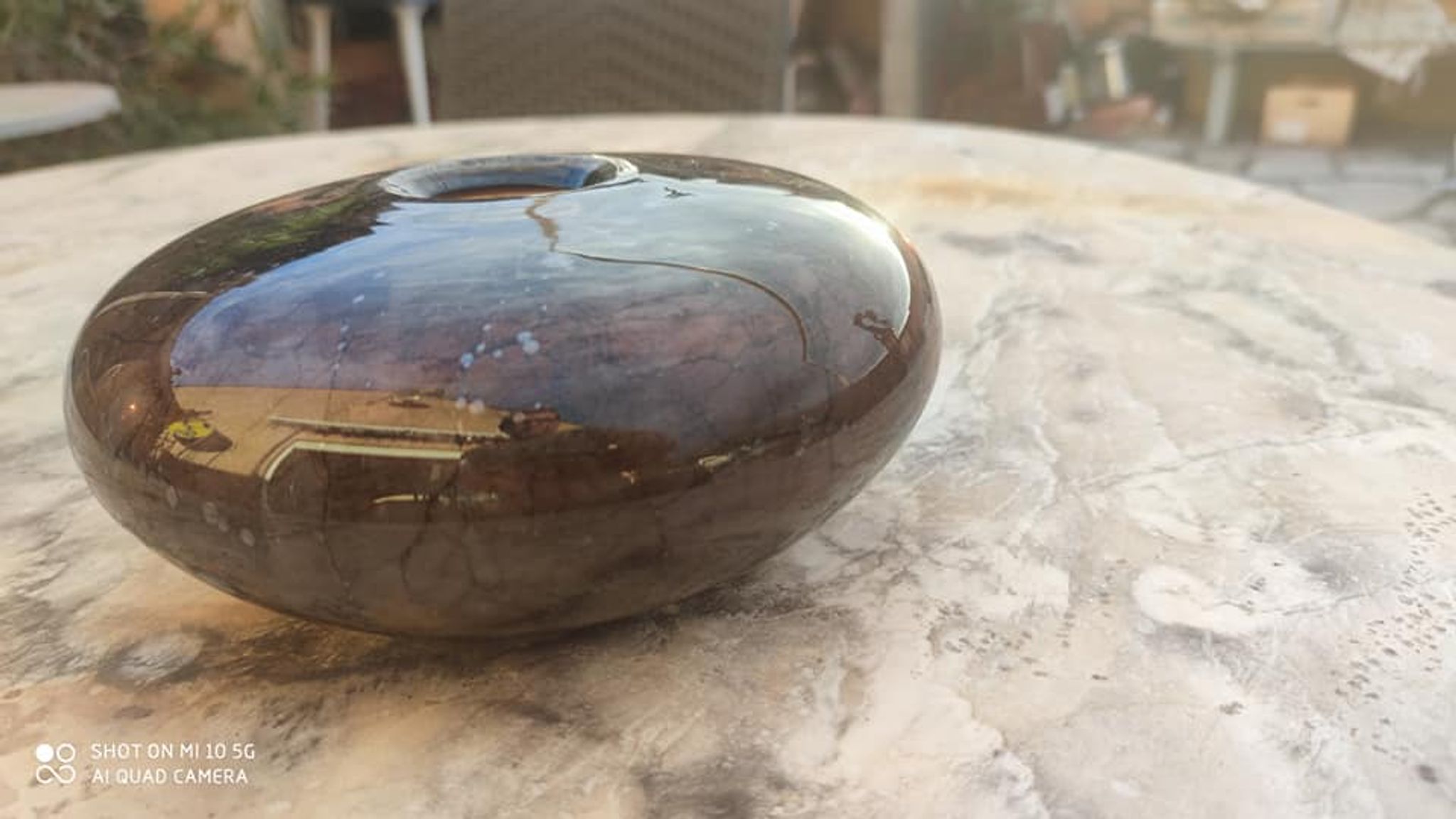 Flattened spherical vase made of glass paste
