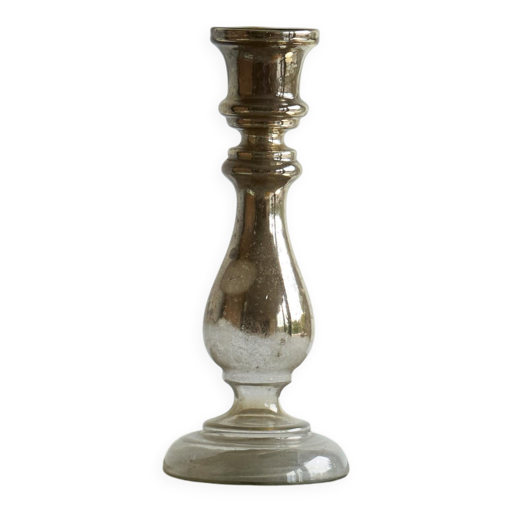 Antique mercury glass candlestick with a patina and silver finish.