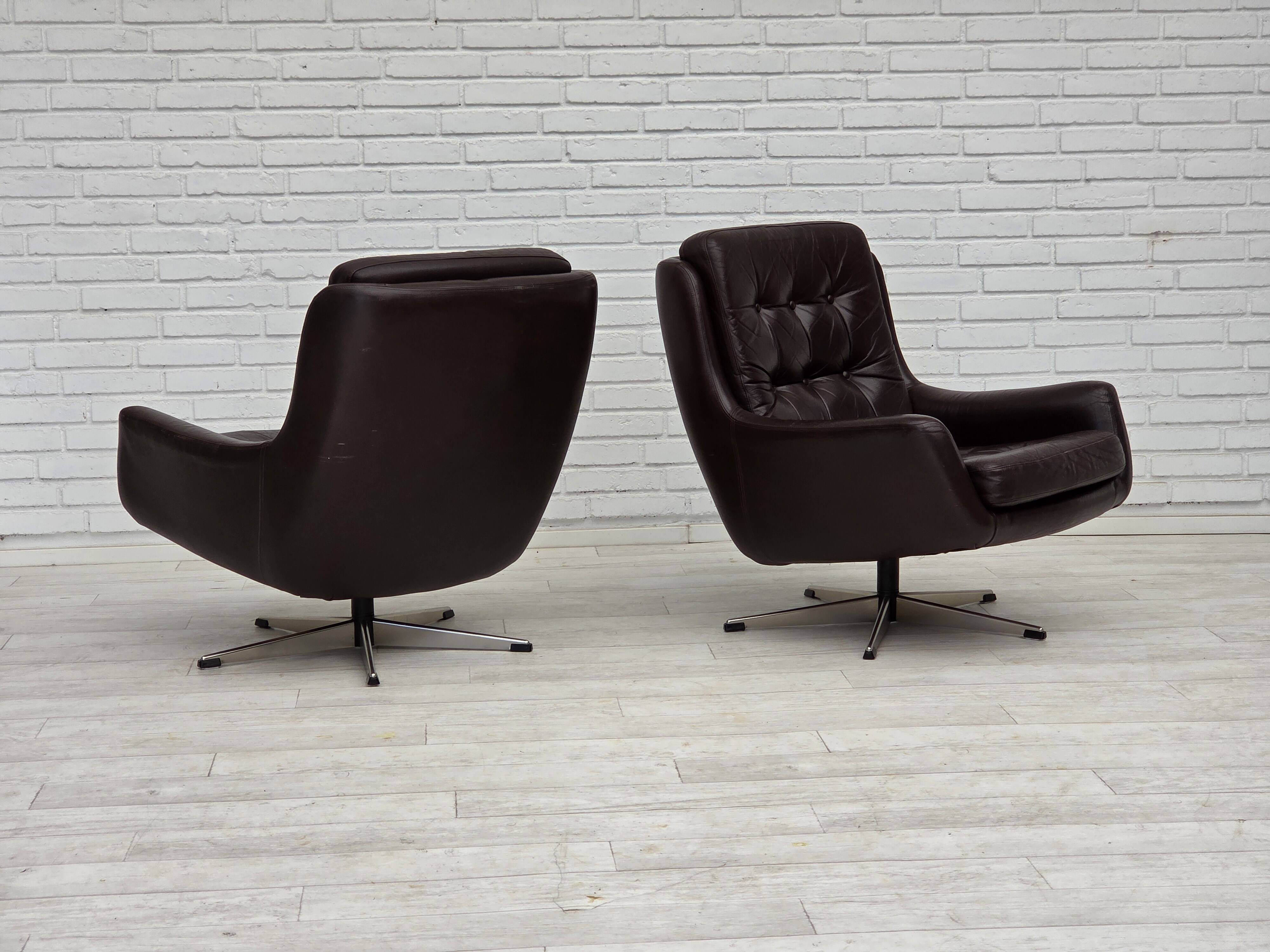 1970s, set of two swivel lounge chairs with footstool, leather.