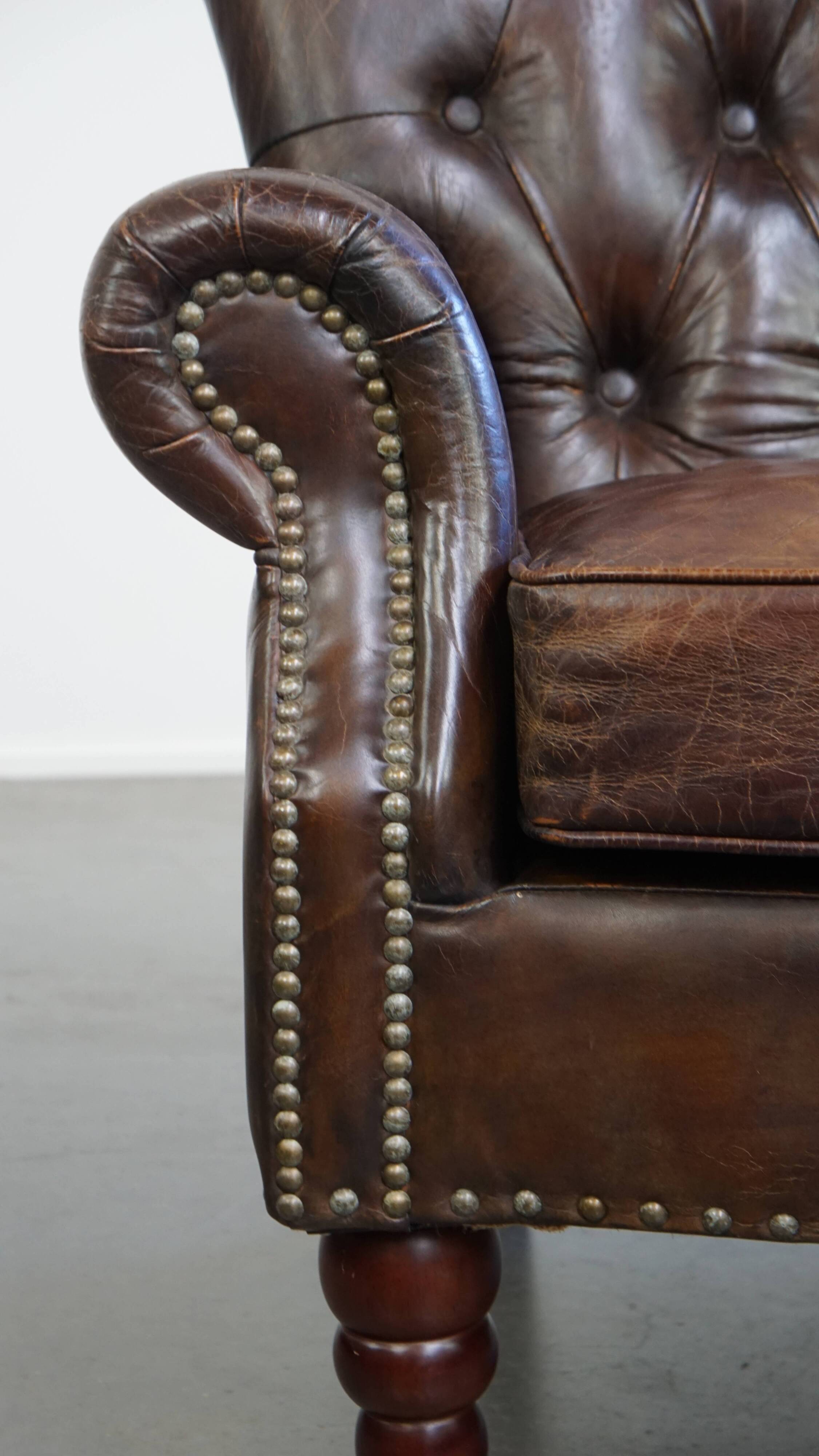 Cognac colored brown grained cowhide chesterfield armchair