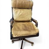 Vintage mahogany and havana leather office chair with wheels from around 1970.