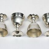 Four silver-plated Christofle egg cups with fluted sides.