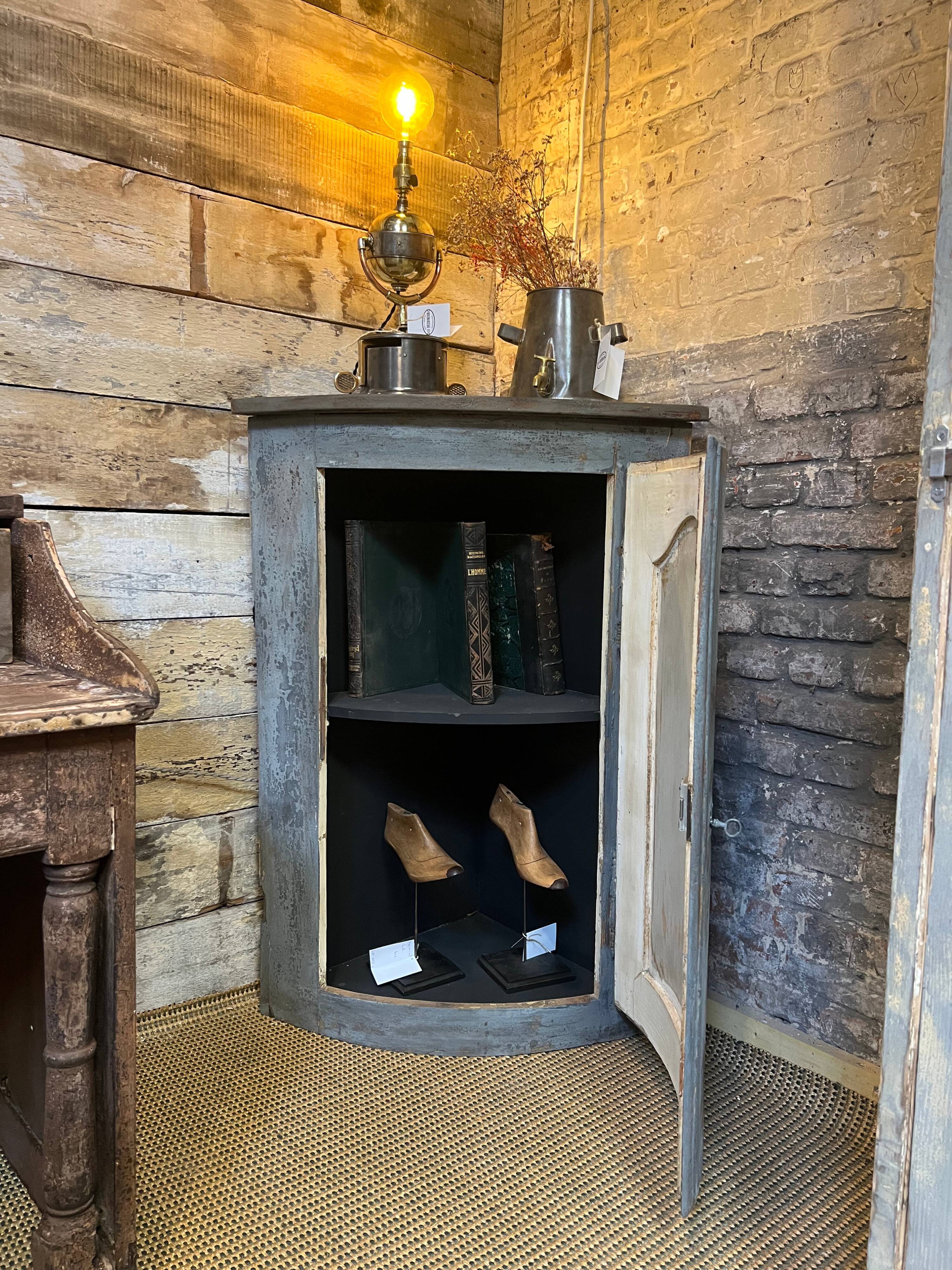 Eighteenth-century corner cabinet with a patina.