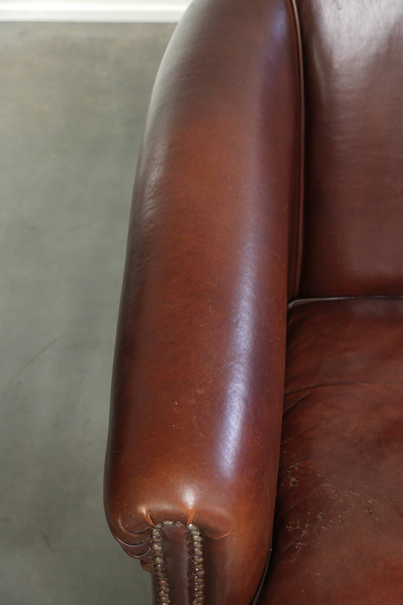 Set of 2 sheepskin club armchairs in a dark cognac colour