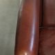 Set of 2 sheepskin club armchairs in a dark cognac colour