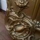 Large antique baroque mirror with angel decorations.