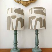 Pair of wooden lamps with custom modernist lampshades.