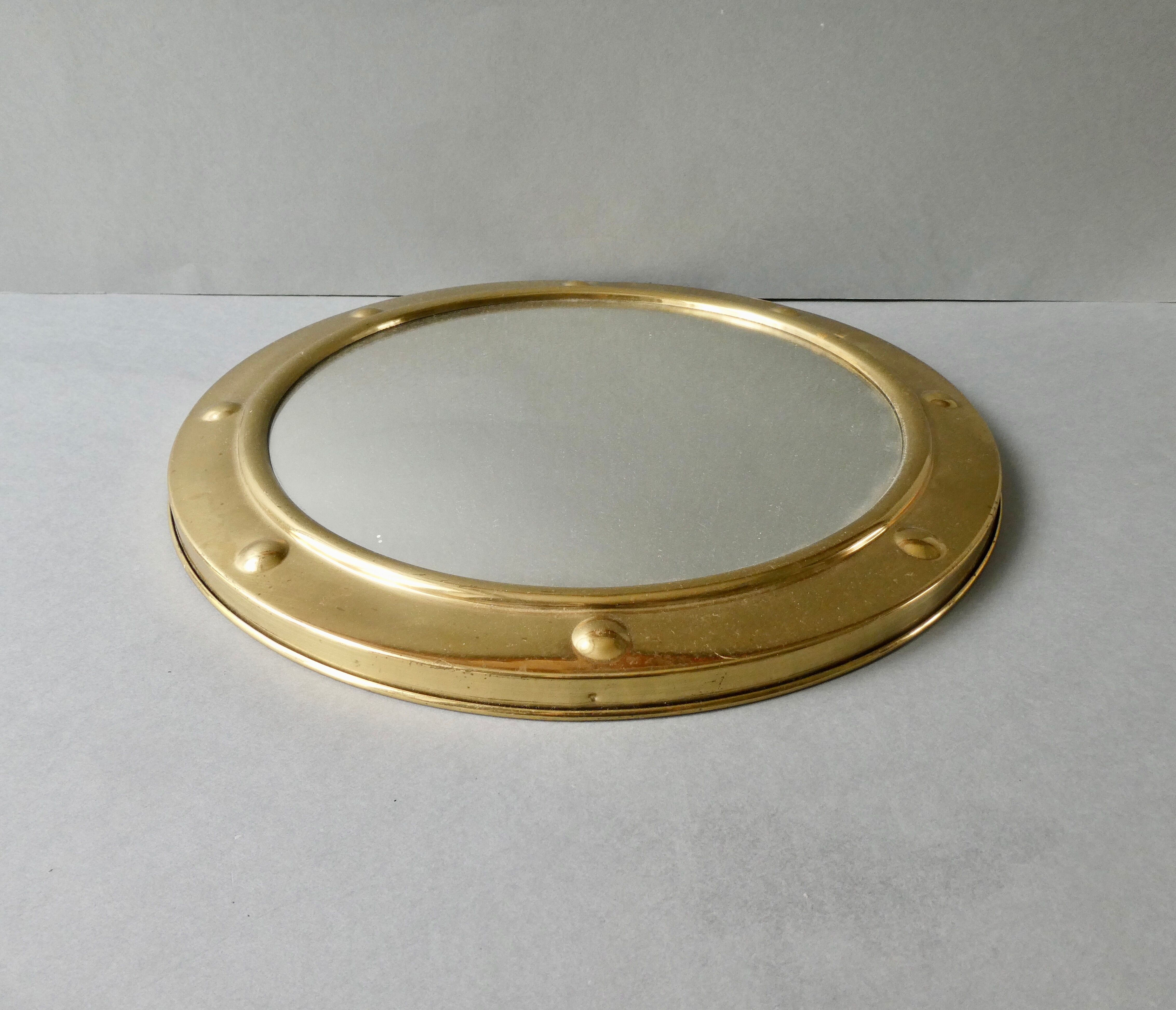 Curved mirror, in a brass porthole, 70s