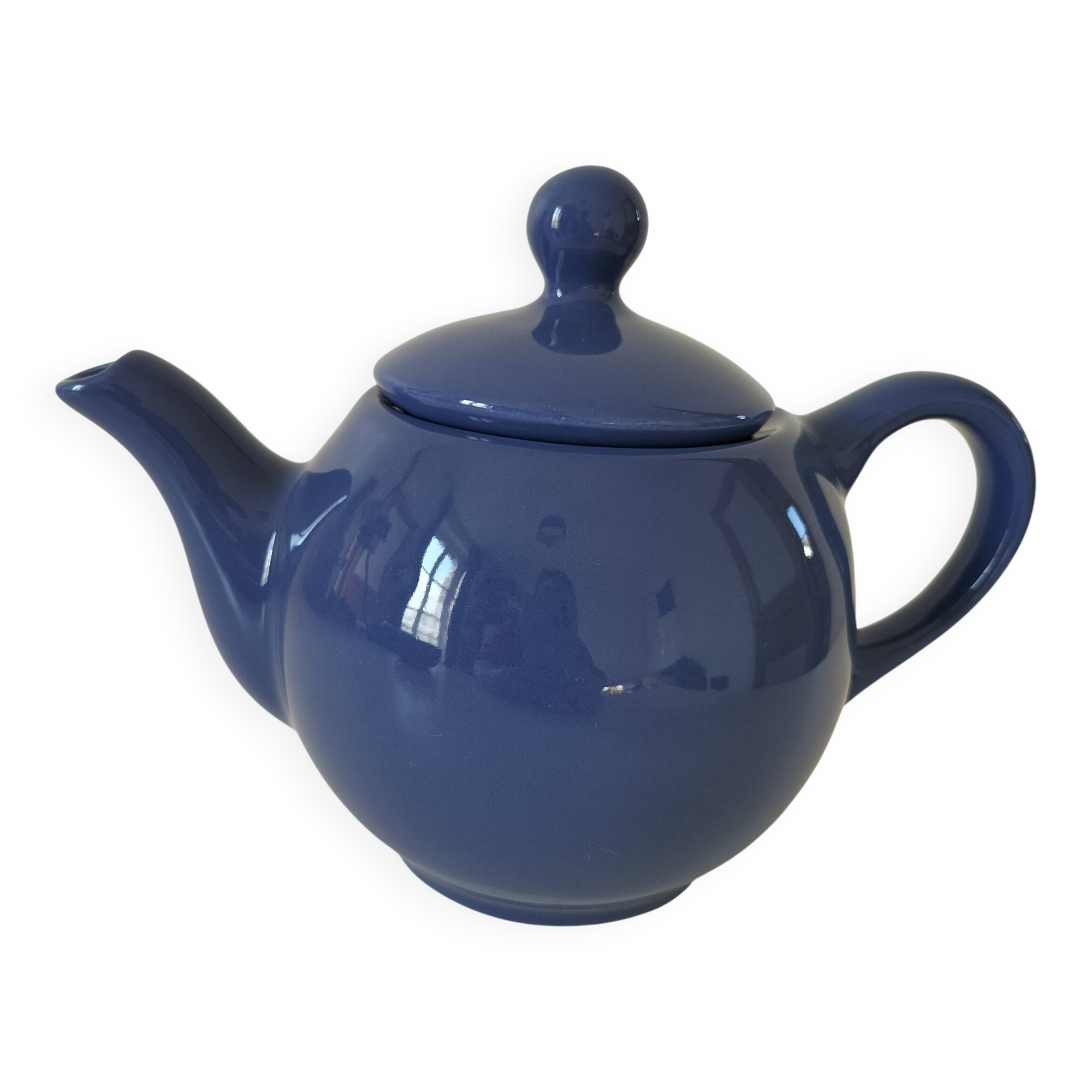 Vintage deep blue teapot, minimalist round shape.