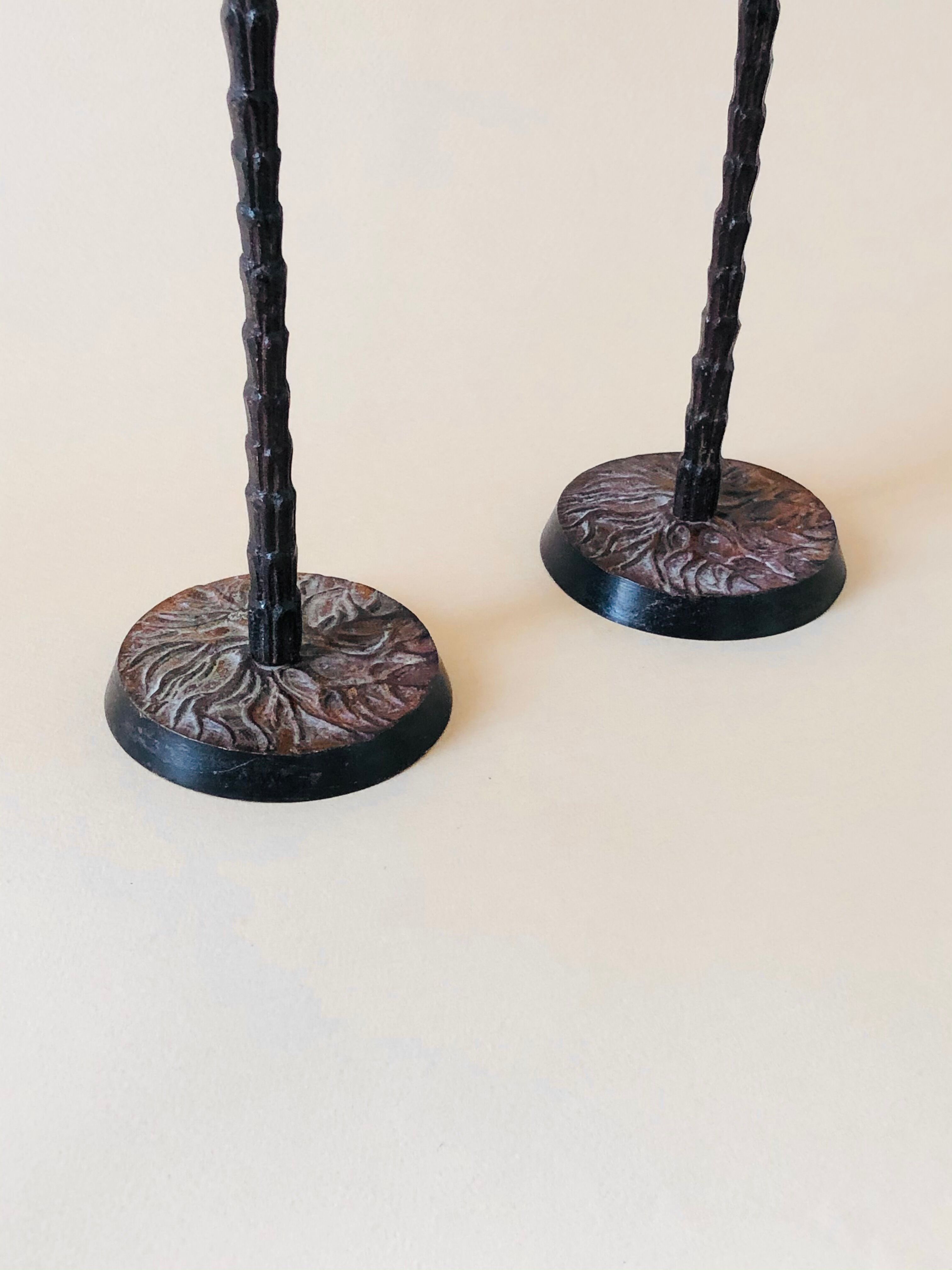 Pair of patinated metal candlesticks