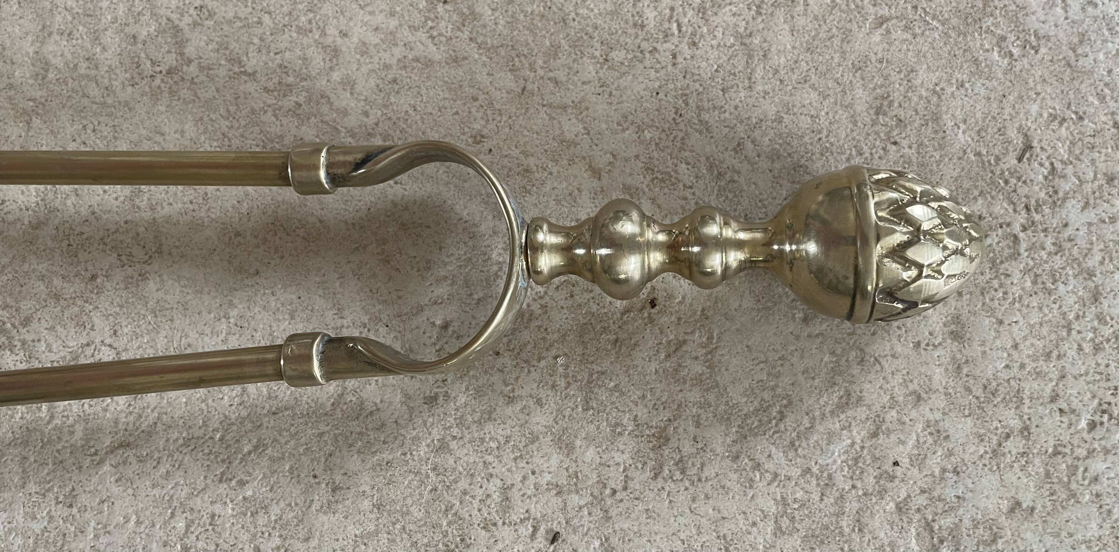 Brass fireplace tools in the style of Maison Baguès.