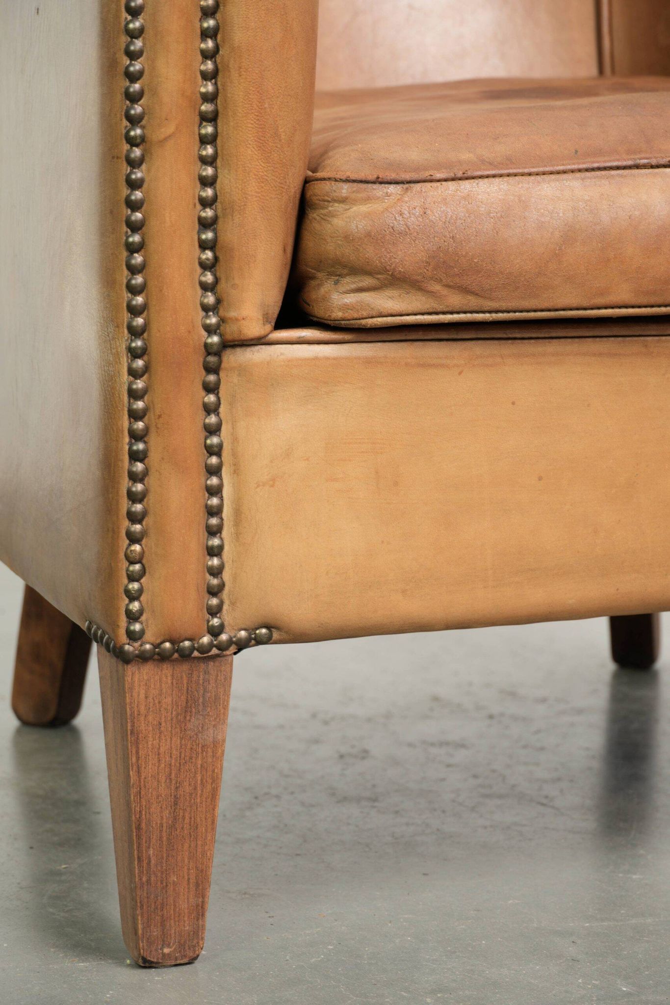 Comfortable sheepskin club armchair in a cognac colour