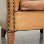 Comfortable sheepskin club armchair in a cognac colour