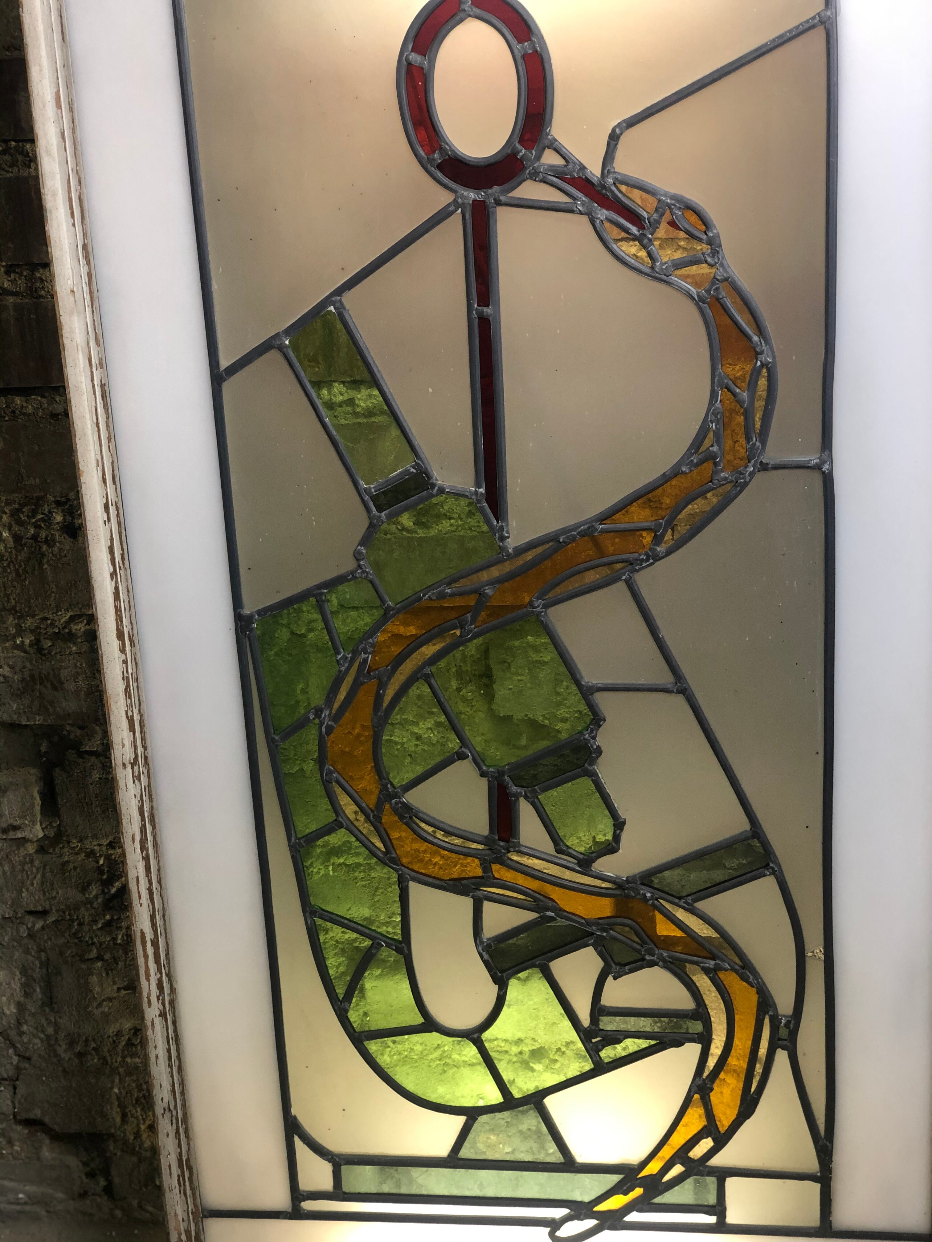 Old stained glass sign with deciduous decoration and microscope