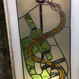 Old stained glass sign with deciduous decoration and microscope
