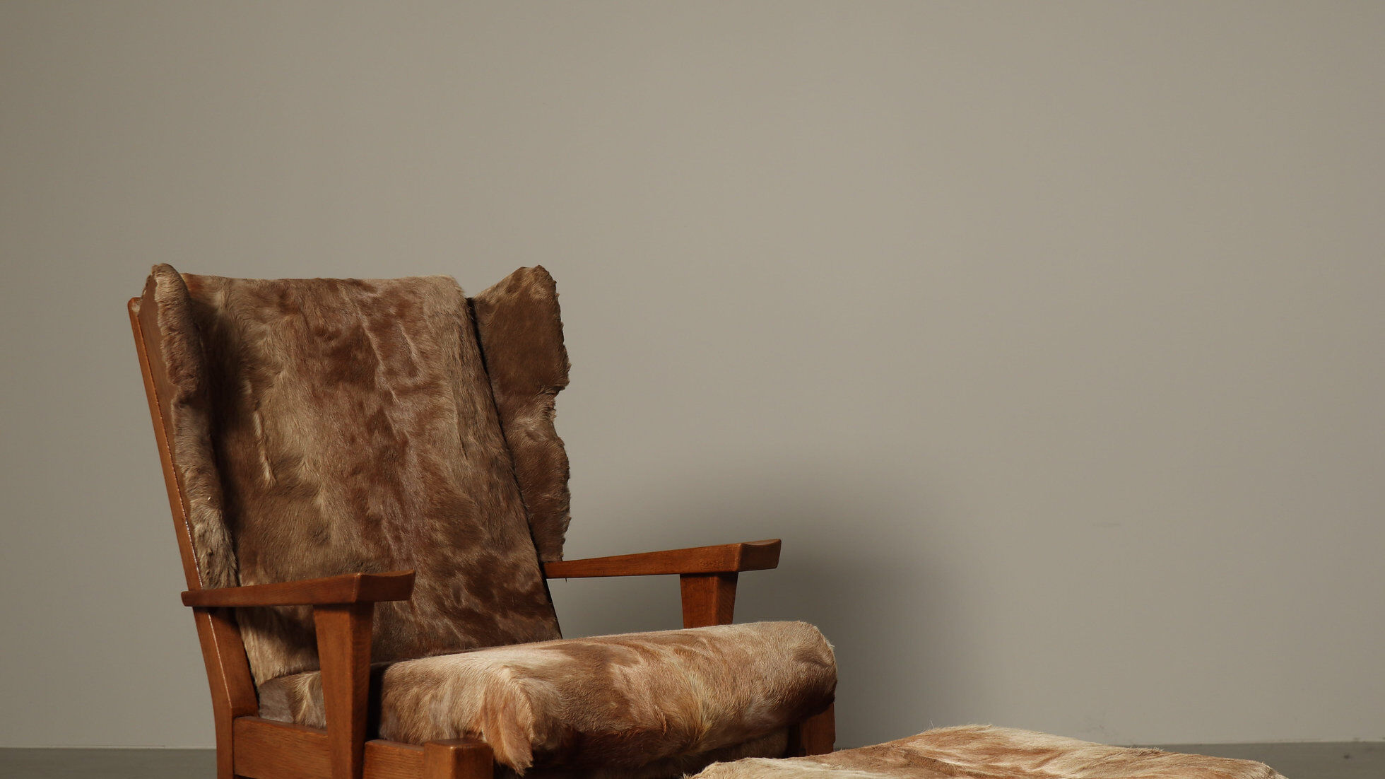 Brutalist oak lounge chair and ottoman in original goat hide, 1960s
