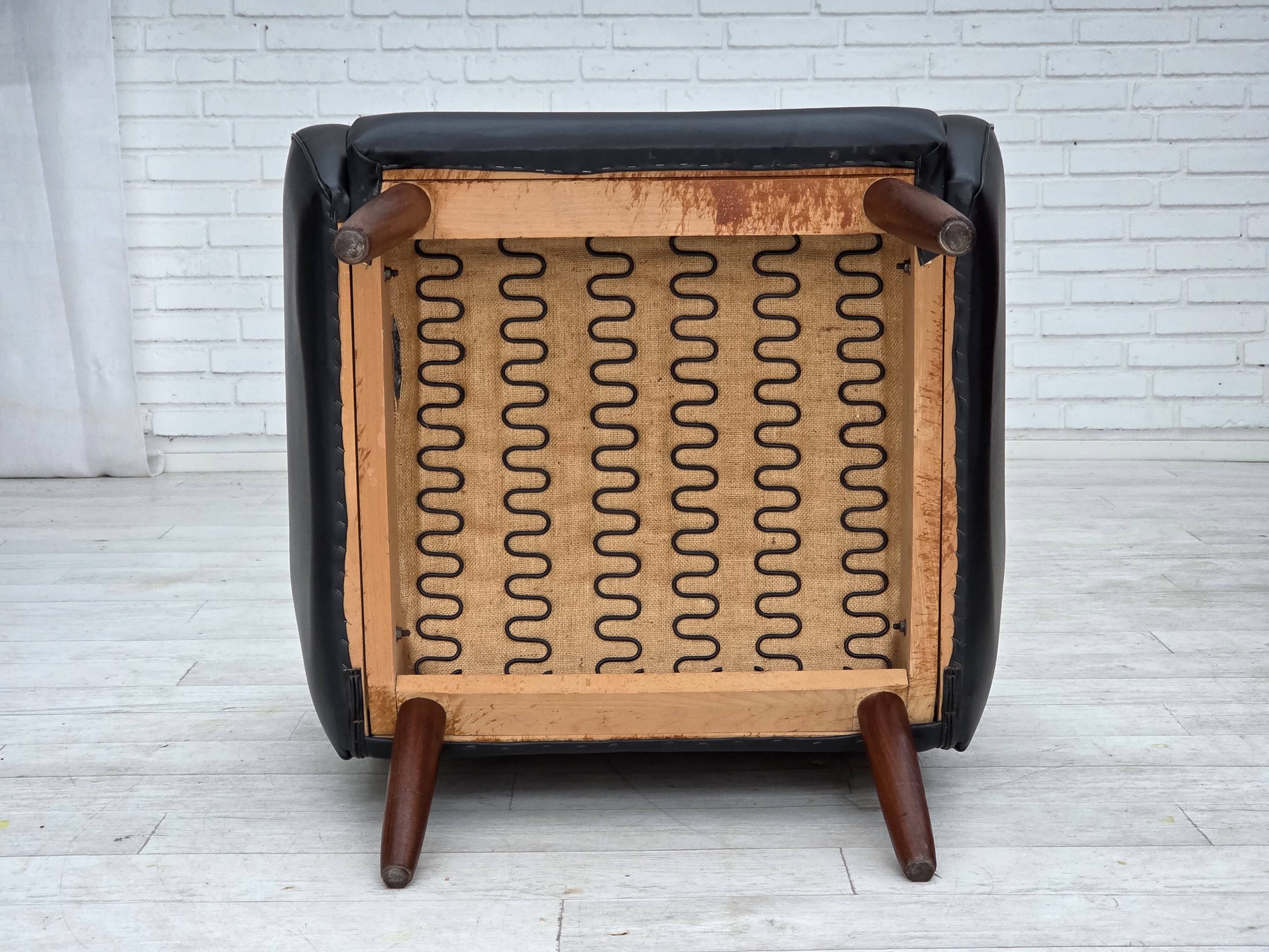 1970s, Danish highback armchair, black artificial leather, teak wood legs.